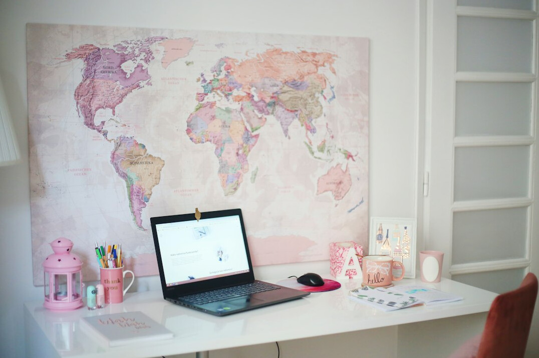 Journalist working desk with laptop and notes in an office