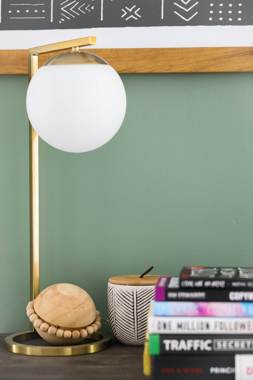 Modest home office with bookshelf and desk lamp